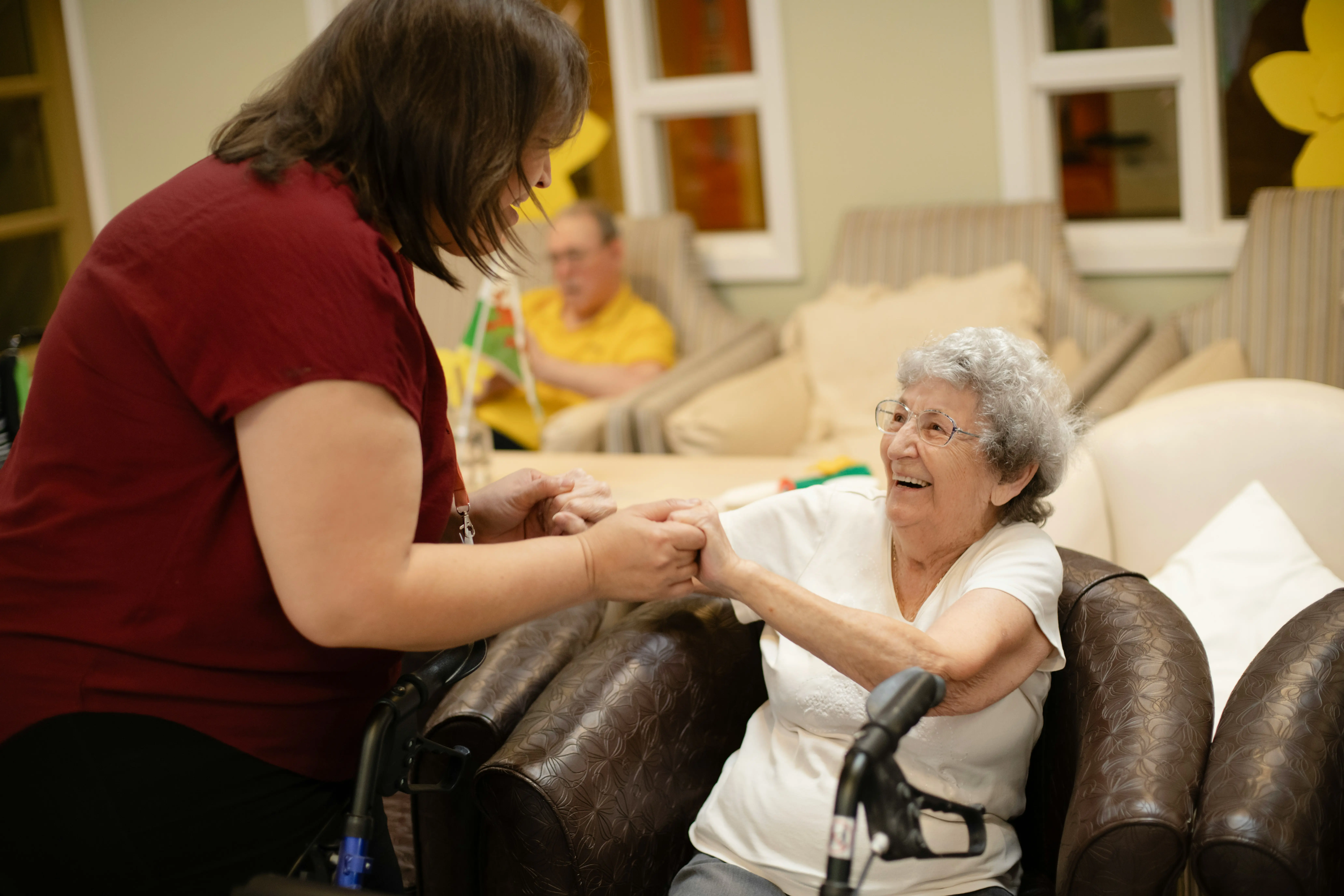 Caregiver holding hands with senior